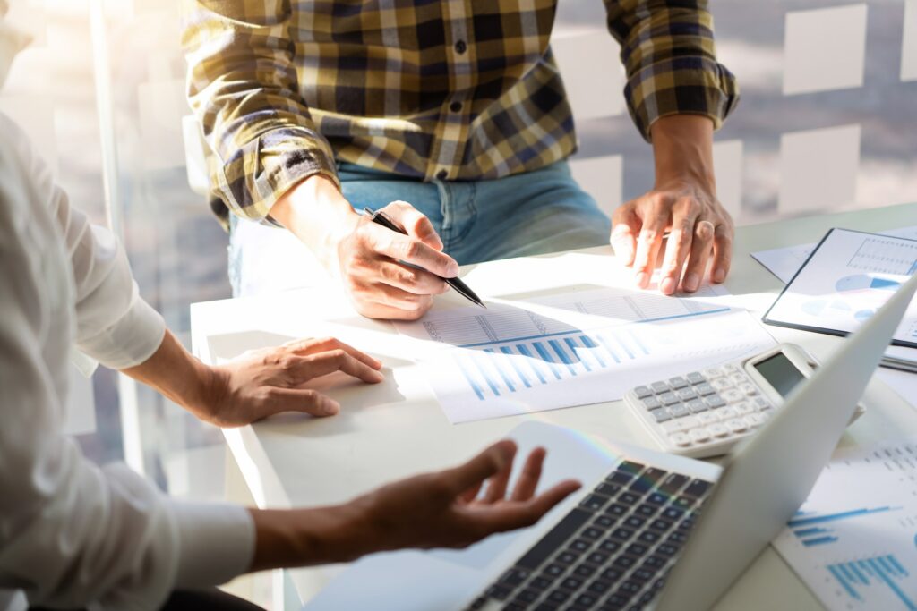 business man financial inspector and secretary making report and brainstorming with colleague in a m